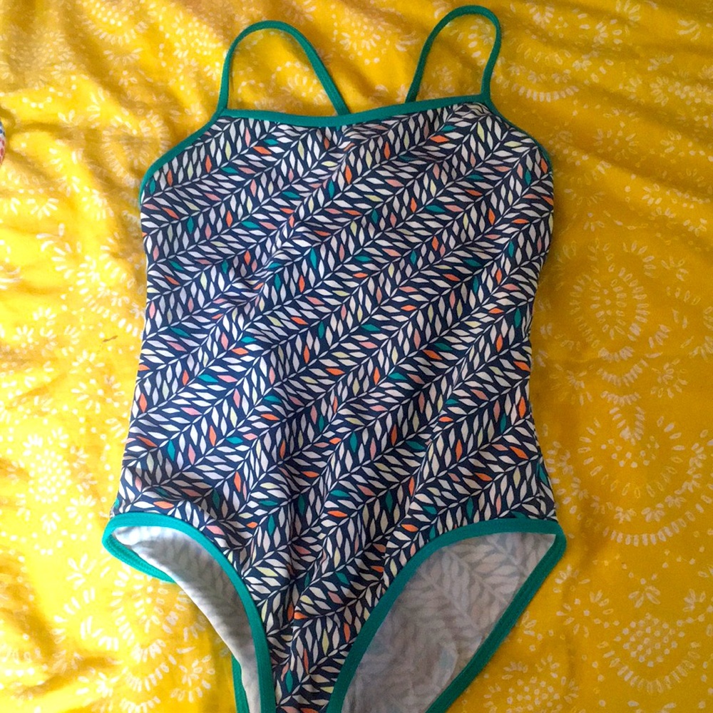 Patagonia girls bathing suit in leaf pattern.